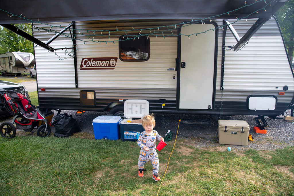 toddler playing in front of RV